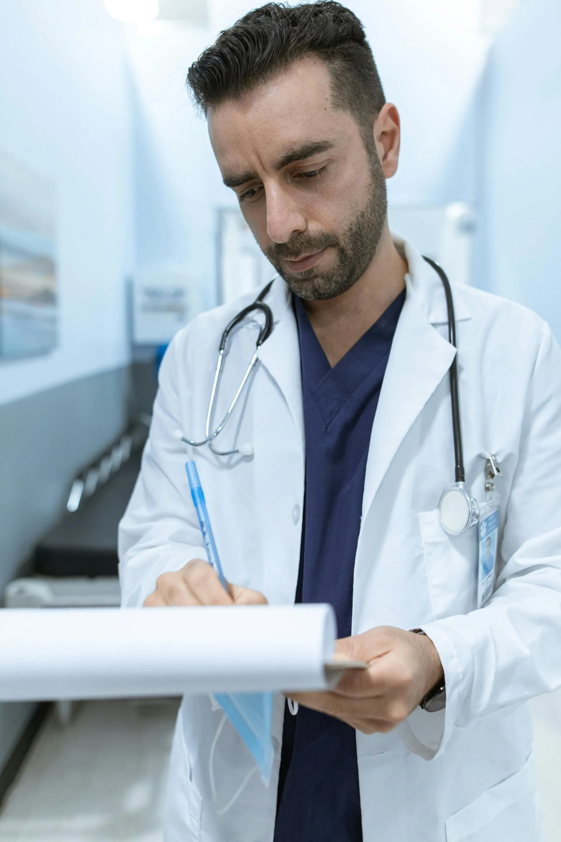Doctor writing on a clipboard