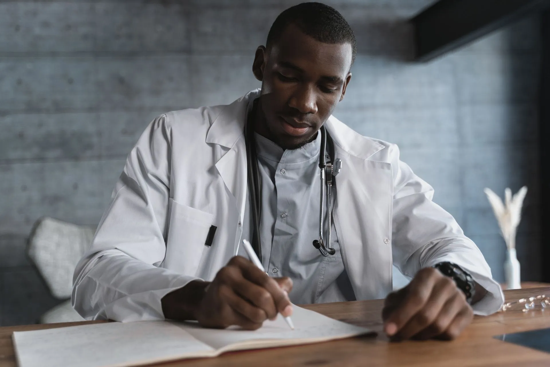 Doctor writing notes at a desk
