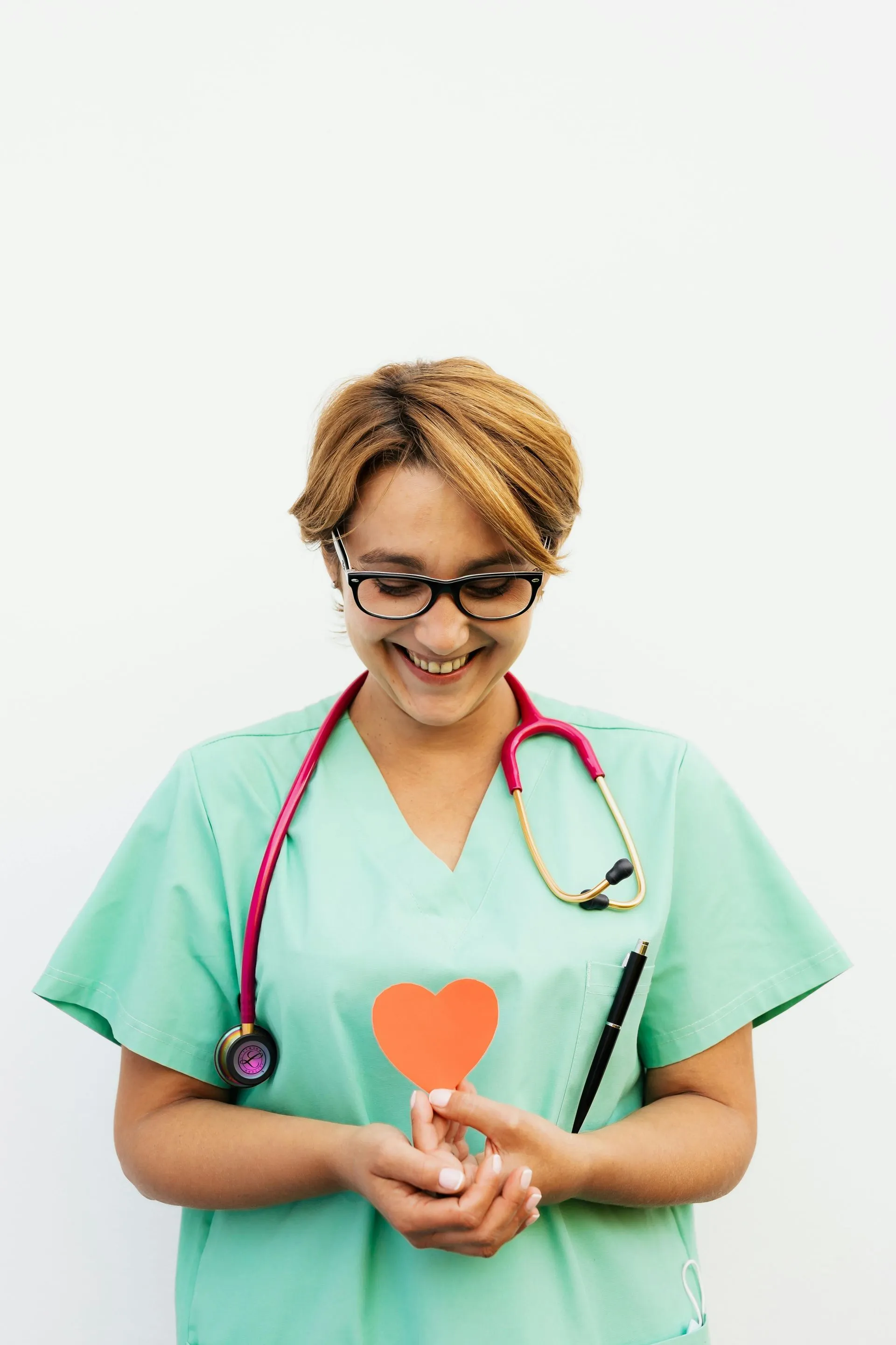 Healthcare worker holding a heart-shaped icon