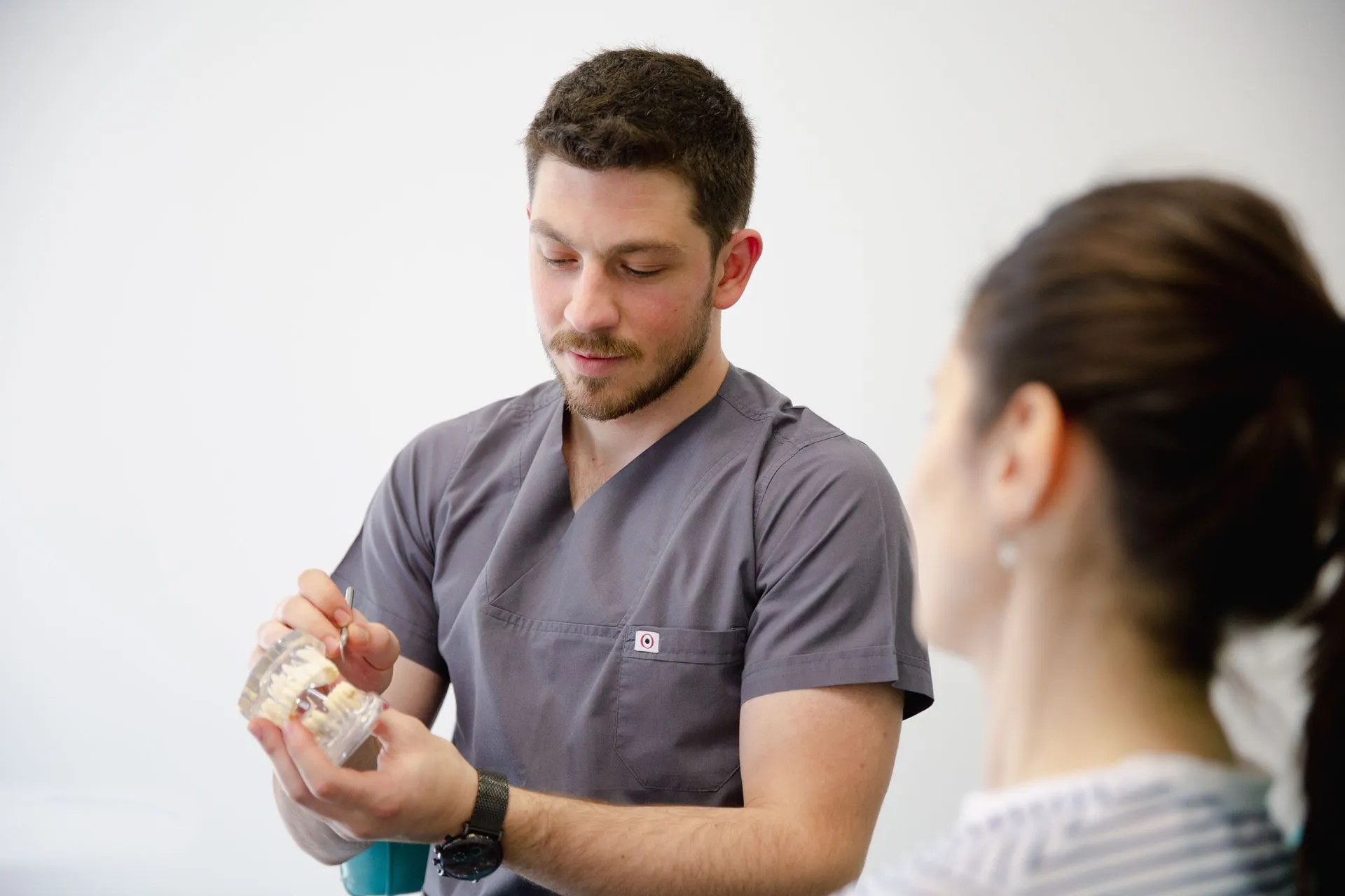 Physical therapist demonstrating a hand exercise