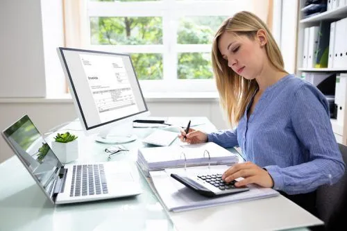 Dental billing professional working on treatment records