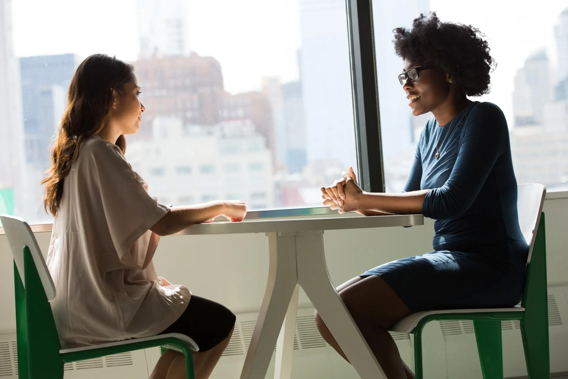 Two colleagues discussing patient billing at a table