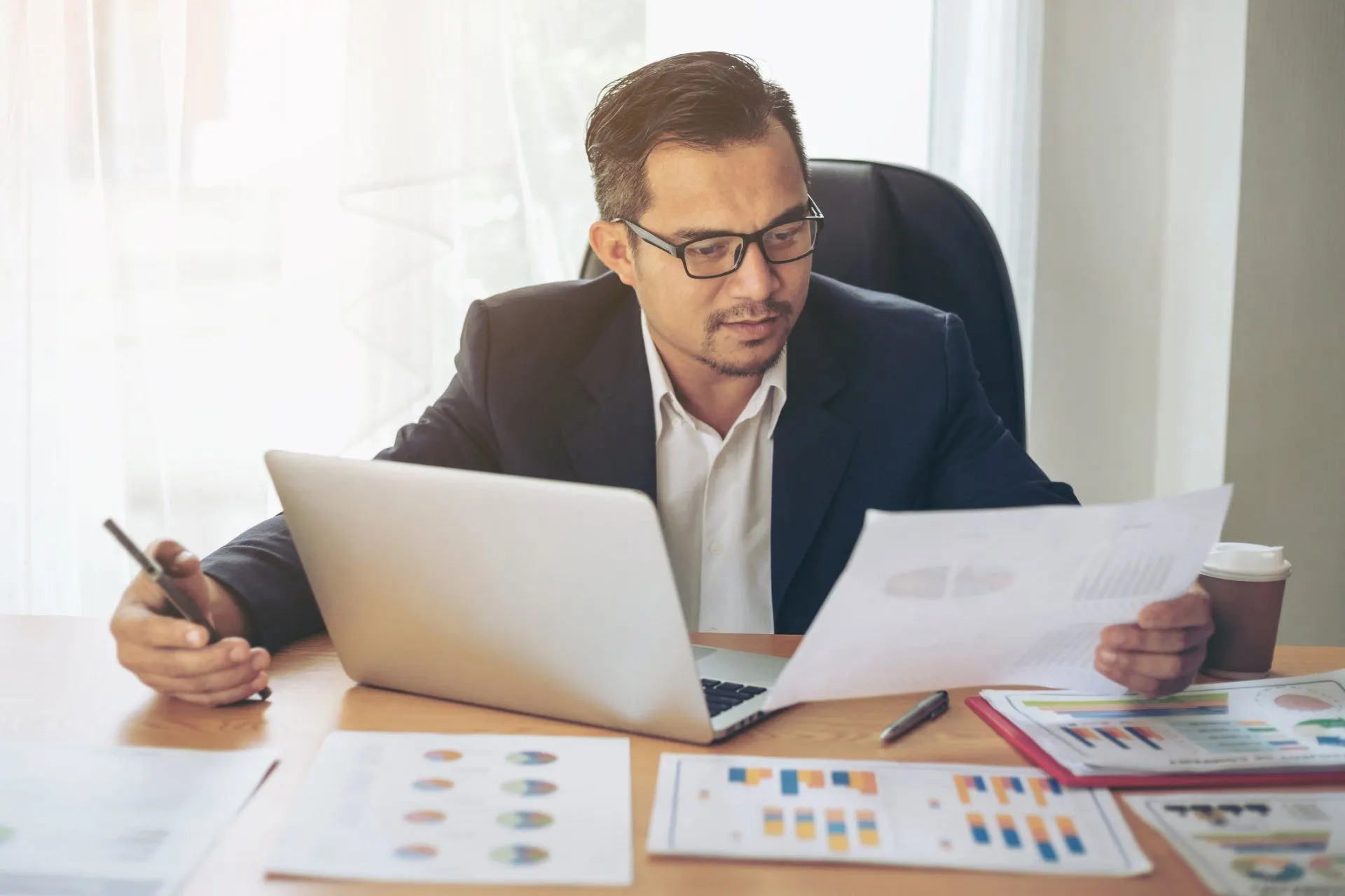 Healthcare billing professional reviewing information on a laptop
