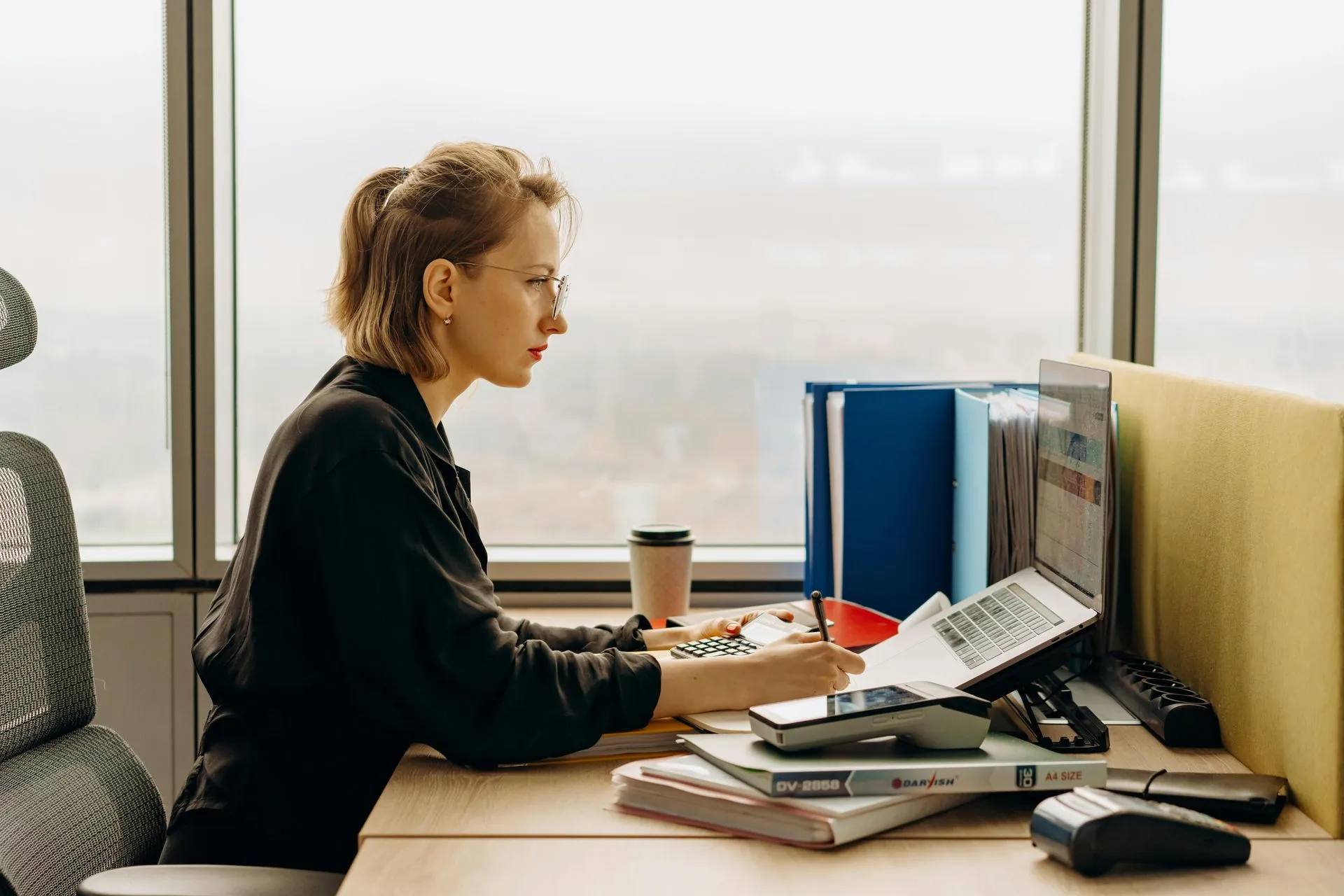 Professional reviewing account documents at a desk